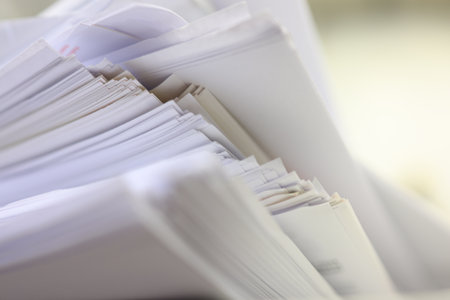 Pile of documents on desk in office, closeup. Selective focus.