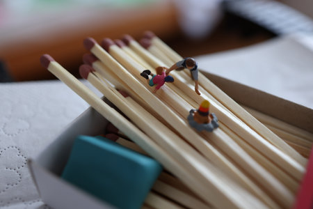 Miniature people : Group of people standing and holding wooden matchsticksの写真素材