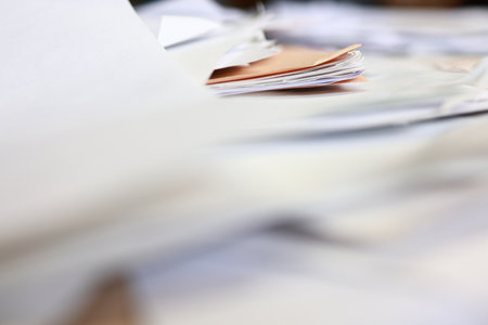 Close-up of a pile of documents on a desk in the officeの写真素材