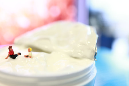 Miniature people : Dentist and patient sitting on the denture.の写真素材