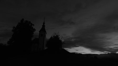 Church in the village at night. Black and white monochrome photo.の写真素材