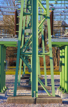 Electricity pylon in the city park on a sunny day.