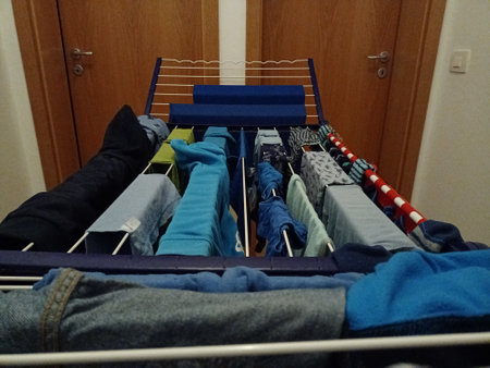 clothes on hangers in the wardrobe of a modern house.の写真素材