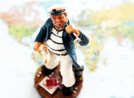Miniature figurine of a pilot on the background of the world map.の写真素材