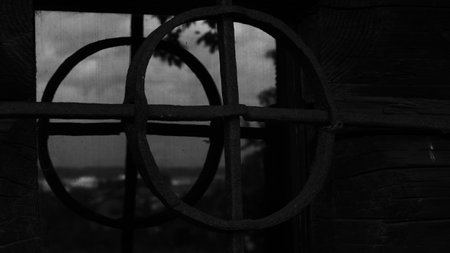 Black and white photo of an old window with a round latticeの写真素材