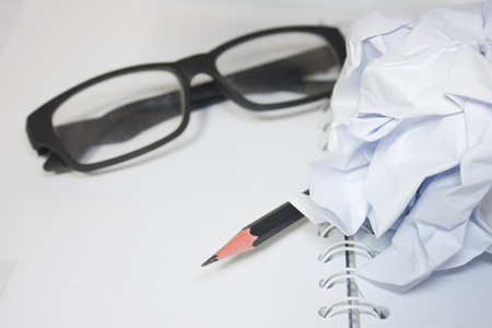 paper with pencil and glasses