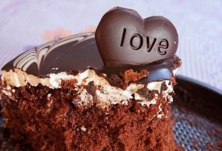 Chocolate cake with dark skin  And implanted with transmitters chocolate heart shape LOVE の写真素材