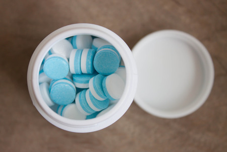Paracetamol tablets, white and blue in the bottle cap の写真素材