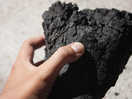 Charcoal fire in handの写真素材