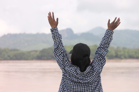 woman with arms outstretched mountainの写真素材