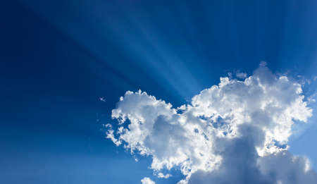 The sun light above the cloud on blue sky