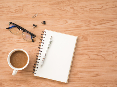 Flat Lay of coffee cup with conflex and office tools over old wooden background. The concept is wooden workspace with copy space background.の写真素材