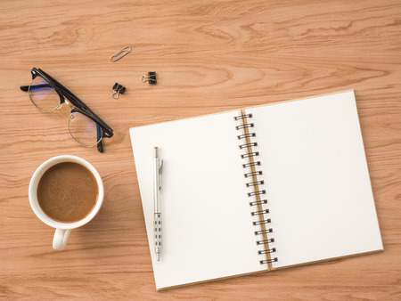 Flat Lay of coffee cup with conflex and office tools over old wooden background. The concept is wooden workspace with copy space background.の写真素材