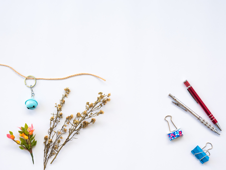 Flat Lay of dry leaf on workspaces with office tools and stationary on white background.の写真素材