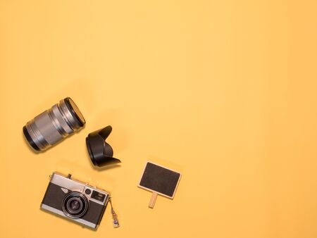 Flat Lay, Top View of Camera and photography tool on yellow background with spaceの写真素材