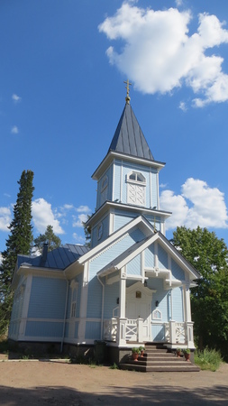 Blue christian church in russian village on a sunny summer dayの写真素材