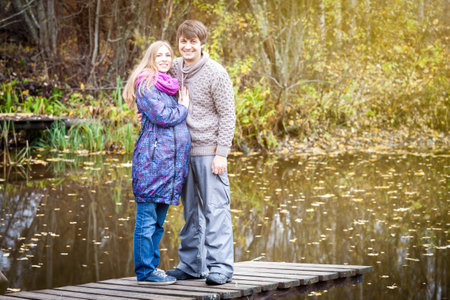 Young couple of future parents on the lakeの写真素材