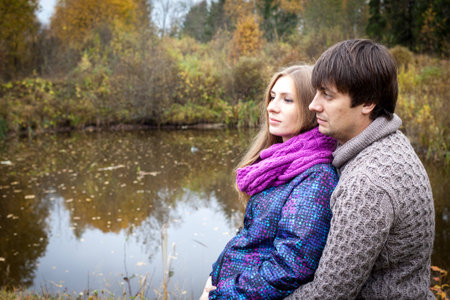 Peaceful couple of future parents on the lakeの写真素材