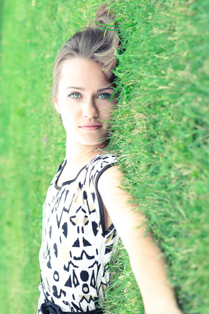 Photo of a beautiful girl on the green grassの写真素材
