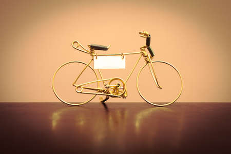 Toy model of the bike, made of gold wireの写真素材