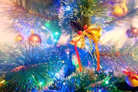Christmas bells in the light colored lightsの写真素材