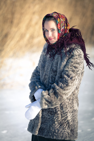 Beautiful Russian girl in national headdress on a winter dayの写真素材