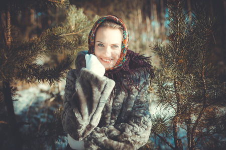Beautiful young woman smiling in a pine forestの写真素材