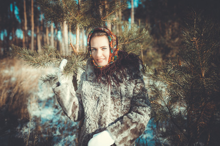 Beautiful young woman taking a walk through the pine forestの写真素材