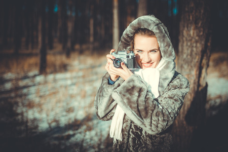 Young beautiful woman photographed in a pine forestの写真素材