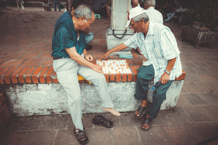VIETNAM, HANOI - 23 SEPTEMBER 2013: local residents relax and play checkers on the island of the Lake of the Restored Swordのeditorial素材