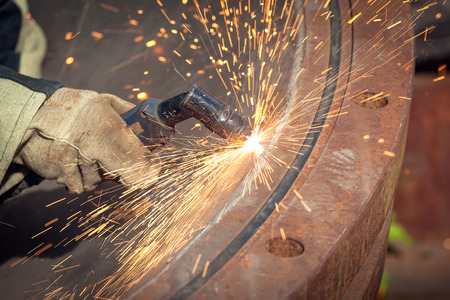 Cutting metal with a manual plasma cutting machineの写真素材