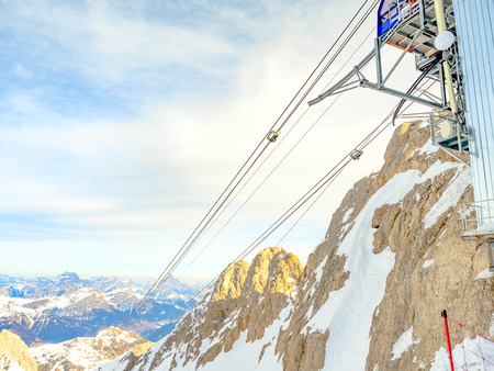 Upper station and cableways of the aerial cableway in the mountainsの写真素材