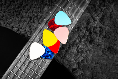 colorful picks on acoustic guitar fingerboardの写真素材