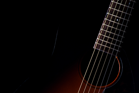 sunburst acoustic guitar & beautiful rim light of six strings, frets and body shape, isolated on...