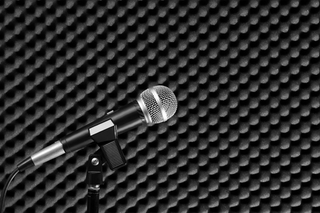 dynamic microphone on acoustic board background in recording studio for music conceptの写真素材