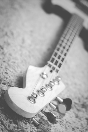closeup electric bass guitar headstock, shallow dept of field, focus on tuner. vintage BW filter for music backgroundの写真素材