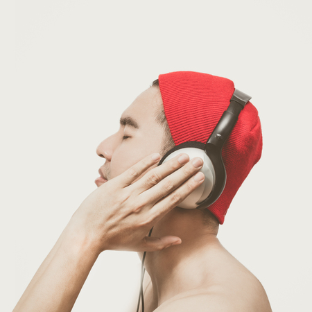 asian handsome man fascinated listening music. vintage film filter