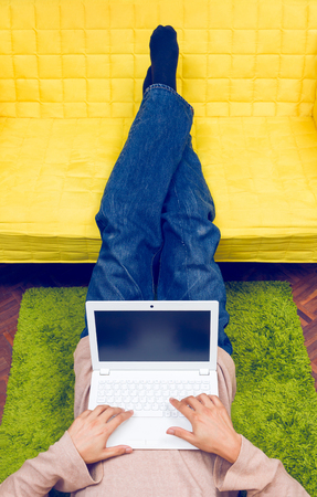 asian man working / playing on white laptop computerの写真素材