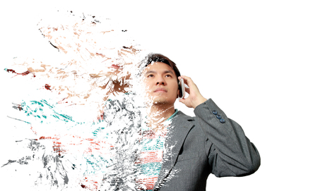 crumbling asian handsome businessman calling mobile phone, isolated on whiteの写真素材