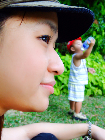 asian young mom looking her son grown up with hope and loveの写真素材