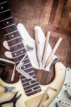 yellow electric guitar on wood in repair & luthier workshop, fixing & musical instrument repairing conceptの写真素材