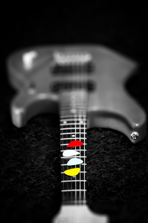 colourful picks on electric guitar fingerboard, music backgroundの写真素材