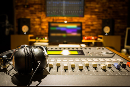 headphones on sound mixer in digital recording studioの写真素材