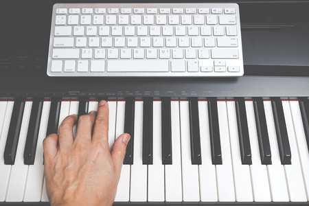 male musician hands playing on piano keys, music computerの写真素材