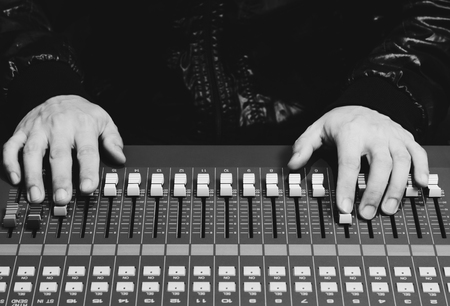 sound engineer hands working on sound mixer, black and whiteの写真素材