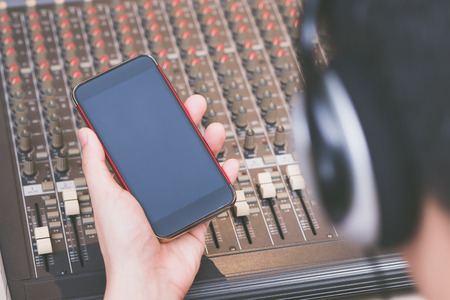 male sound engineer listening music and shopping onlineの写真素材
