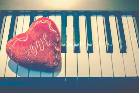 red heart on piano keys, vintage filter. music backgroundの写真素材