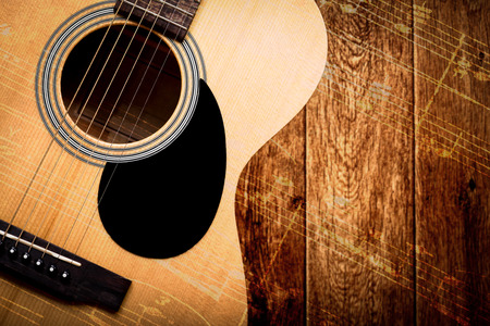 acoustic guitar on wood with music note