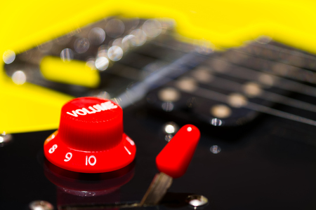 red volume knob on electric guitar, music backgroundの写真素材