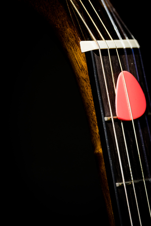 pink pick on guitar neck, music backgroundの写真素材